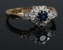 An 18ct Gold and Platinum diamond and sapphire cluster ring. Size K. Total weight: 2.5g