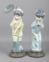 Two Lladro Geisha Girls; with one holding a parasol. Tallest: 29cm. No damage, putty has been