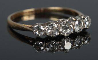 An 18ct Gold and Platinum five stone Diamond ring, the largest stone being just under Â¼ct. Size