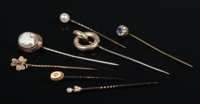 Seven Victorian stick pins, including Cameo, shamrock and seed pearl set examples.