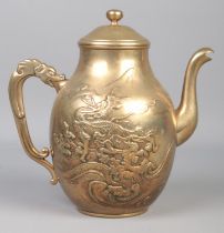 A Chinese brass teapot decorated with a dragon and dragon handle. (21cm)