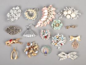 A collection of costume jewellery brooches, to include animal, large leaf, peacock and bow examples.