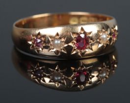 An 18ct Gold, Ruby and Pearl gypsy set ring. Size O. Total weight: 2.8g