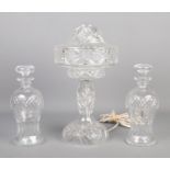 A cut glass table lamp along with pair of cut glass decanters.