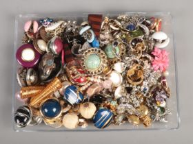 A tray of costume jewellery earrings, including large polished stone, spring and clip on examples.