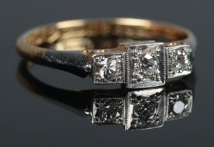 An art deco 18ct Gold, Platinum and three stone Diamond ring. Size L. Total weight: 1.9g.