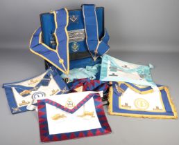 A Masonic case with contents of aprons etc. Including Nottinghamshire examples.