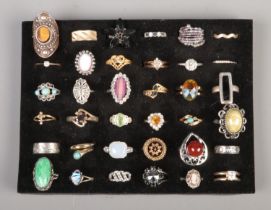 Thirty-six dress rings, to include cameo, abalone and crucifix example.