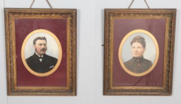 A pair of framed early twentieth century oleograph portraits with applied oil paint detail depicting