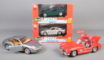 Four diecast cars, including two boxed Revell 1:24 scale examples; Porsche 959 and BMW Z1.