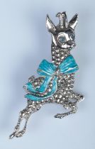 A white metal and marcasite Babycham brooch. Wear to the bow on the brooch.