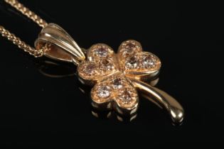 An 18ct Gold and Diamond shamrock pendant, on 18ct Gold Starlink chain. Total weight: 5.2g