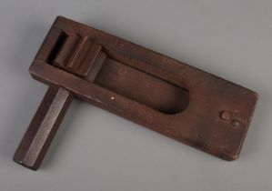 A World War Two wooden gas rattle, stamped RCD 1944 and bearing broad arrow mark.