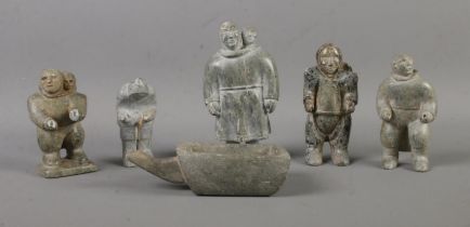 A collection of Inuit carved soapstone figures formed as working villagers. Makers mark carved to