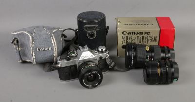 A Canon AE-1 Program 35mm film camera along with collection of Canon lenses. Lenses include 28mm,