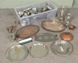 A large box of metalwares. Includes ewers, tankards, candlesticks, trays, etc.