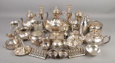 A large collection of silver plated items. Includes tea sets, candlesticks, toast racks, salts,