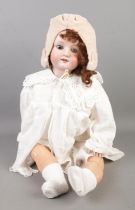 A Max Oscar Arnald bisque head doll, with jointed body. Marked MOA, Germany 200 9. 71cm. Little