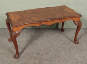 A bur walnut coffee table featuring cabriole legs with carved scroll detail. Approx. dimensions 90cm