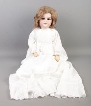 An Armand Marseille bisque head doll, with jointed body. Marked to the back of the head, 390 A11M.