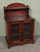 A mahogany glazed smokers cabinet featuring castors to base and inlay to upper shelf. Approx.