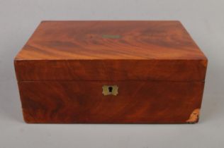 An early 20th century mahogany box with green velvet interior and brass detailing. veneer missing