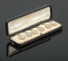 A cased set of six 9ct Gold and Mother of Pearl buttons, in fitted case. Stamped 9ct and GAF to