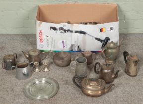 A box of metalwares. Includes teapots, dwarf candlesticks, sugars bowls, toast rack, etc.