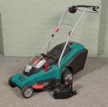 A Bosch Rotak 43 Li cordless lawnmower to include charging station and spare battery. In working