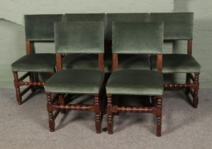 A collection of six green velvet upholstered chairs featuring bobbin turned supports.