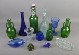 A collection of mostly coloured glass items including large Grolsch lager bottle, Callestock Cider