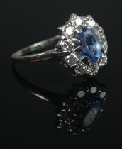 An 18ct White Gold, Sapphire and Diamond cluster ring, with central stone surrounded by ten