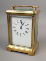 A French carriage clock with open top escapement and Roman numeral markers.