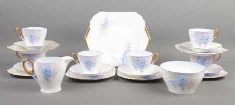 A six place Shelley part tea service, in the Wisteria pattern. Contains cups, saucers, side