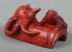 A Japanese carved Netsuke in the form of a Kappa and octopus on barrel