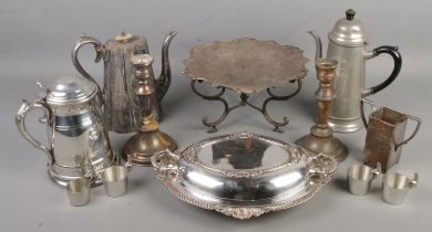 A quantity of metalware. Includes silver plate tureen, ornate teapot with mother of pearl finial,