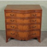 A serpentine chest of four drawers featuring a pull out desk. Approx. dimensions 77cm x 50cm x 78cm.