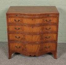 A serpentine chest of four drawers featuring a pull out desk. Approx. dimensions 77cm x 50cm x 78cm.