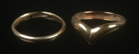 Two 9ct gold rings to include wedding band and wishbone examples. Both rings size KÂ½, total