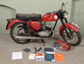 A BSA Bantam D10 motorbike and accessories. Includes additional fuel tank, replacement seat cover,