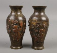 A small pair of bronze overlaid baluster shaped vases. Decorated with figures and flowers. Height