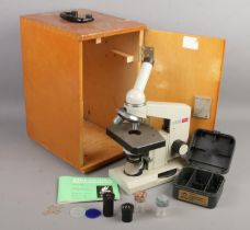 A cased Russian Nomo Biological microscope with accessories.