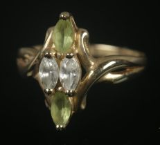 A 9ct gold marquise shaped ring set with green and clear paste stones. Size L, 2.87g.