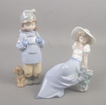 Two Nao porcelain figures. Includes travelling girl with dog and reclining girl with bird.