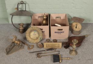 Two boxes of mostly brassware. Includes rearing horse figure, large key, hanging oil lamp, erotic