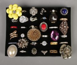 A collection of thirty-six costume dress rings to include stacking, signet and coiled snake
