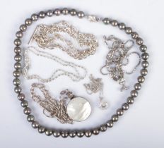 A collection of silver necklaces to include mother of pearl example along with a silver clasped