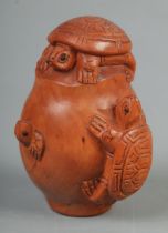 A Japanese carved Netsuke in the form of three tortoise on an egg
