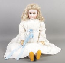 A vintage bisque head doll, marked '10 SH 10 Germany', possibly Simon & Halbig. Additional stamp