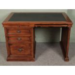 A stained pine kneehole desk with leather inset top.